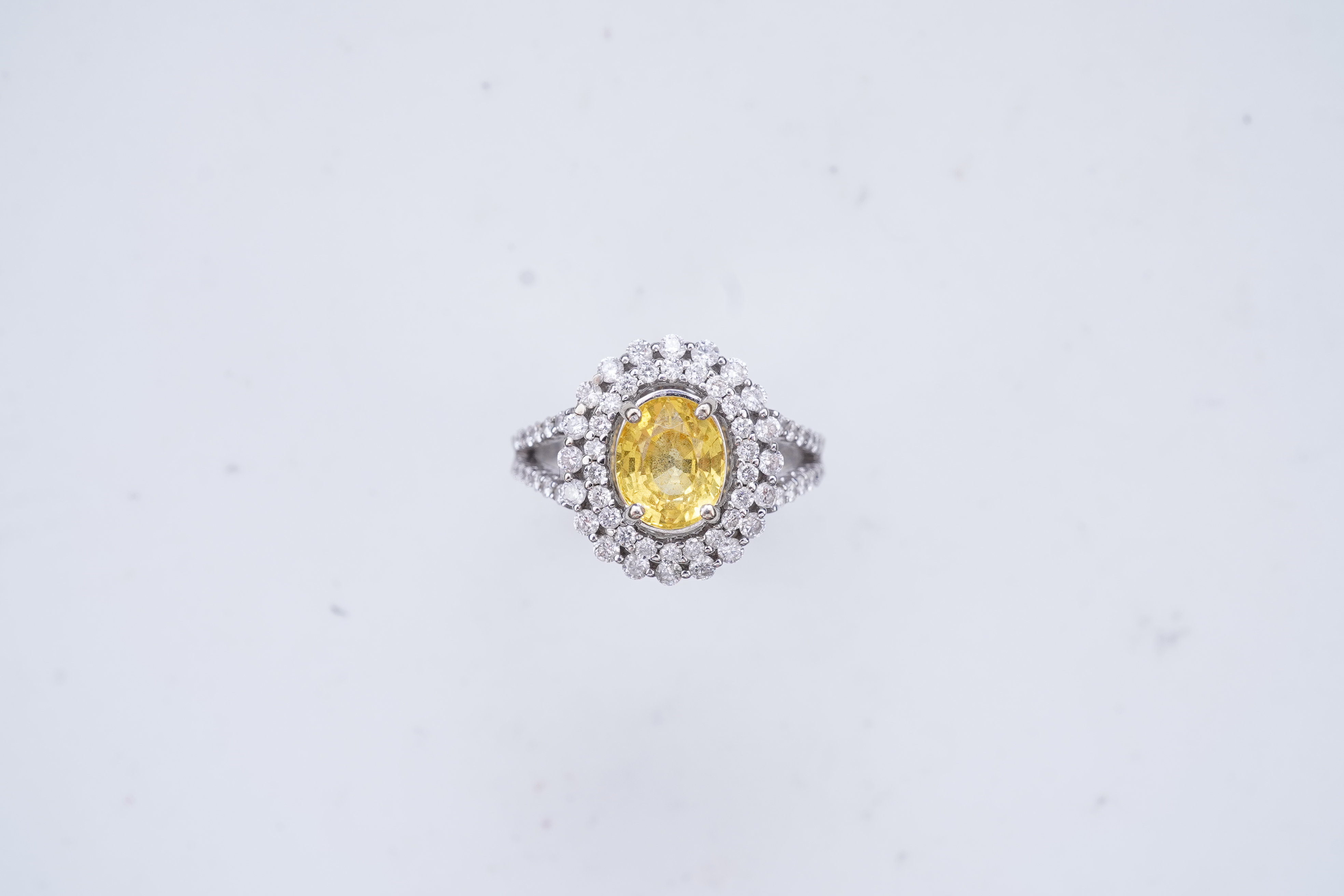 A yellow sapphire and diamond ring